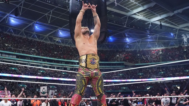 Will Ospreay poses in the ring inside Wembley Stadium, title belt around his waist at AEW All In