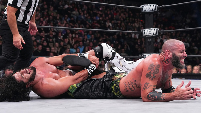 Rush with a submission hold on Mark Briscoe