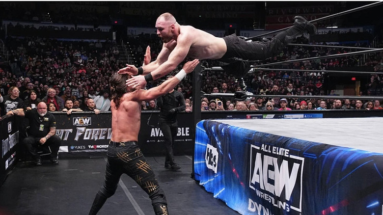 Jon Moxley dives onto Jay White on the outside