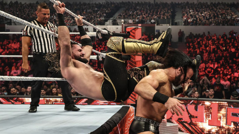 Seth Rollins kicking Drew McIntyre