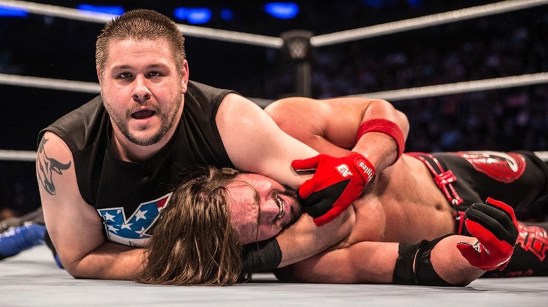 Kevin Owens has AJ Styles in a headlock