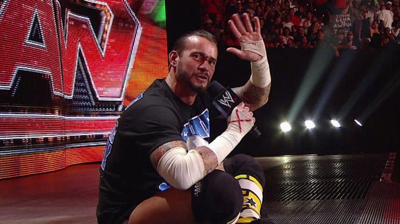 CM Punk waves to the camera during his infamous pipe bomb promo