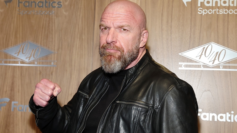 Triple H is wearing a black leather jacket.