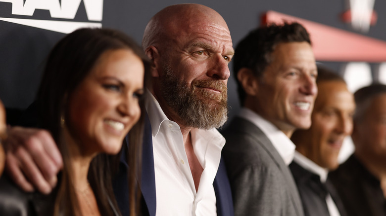 Paul "Triple H" Levesque standing with Stephanie McMahon and TKO executives