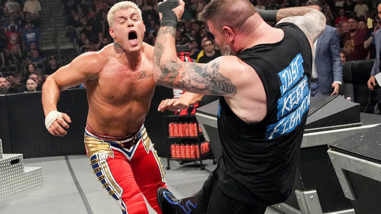 Kevin Owens kicking Cody Rhodes in the knee