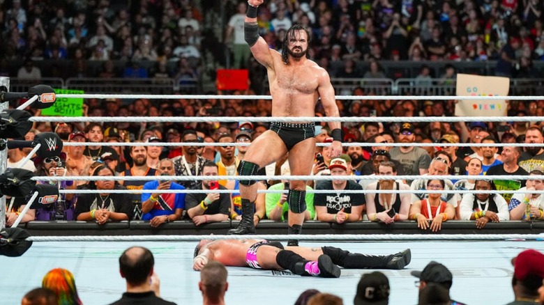 Drew McIntyre stands over CM Punk after defeating him at SummerSlam.