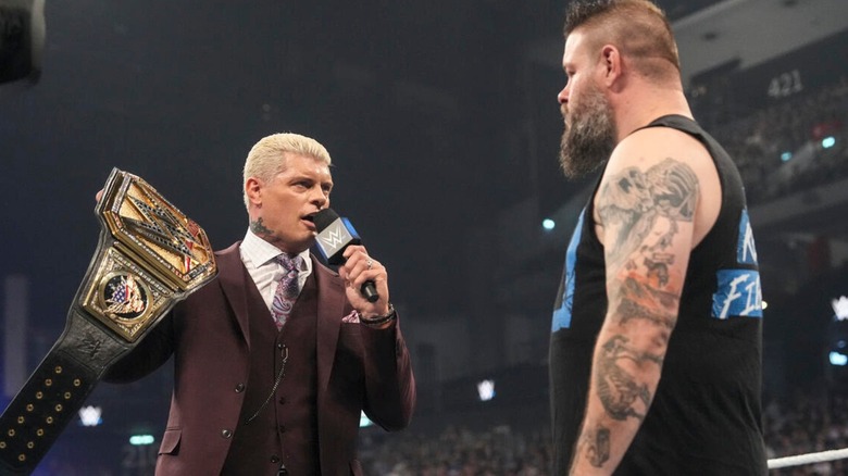 Cody Rhodes holds up the Undisputed WWE Championship while cutting a promo on Kevin Owens in the ring during "WWE SmackDown."