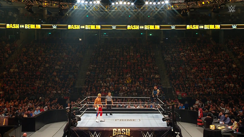 Rhodes and Owens staring one another down in the ring