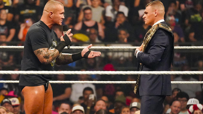 Randy Orton talking to GUNTHER on microphone