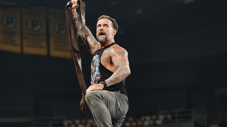 CM Punk holding up strap