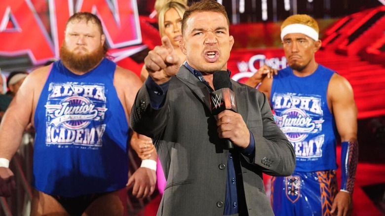 Chad Gable points to the ring from the ramp, flanked by Otis, Maxxine, and Tozawa of the Alpha Academy.