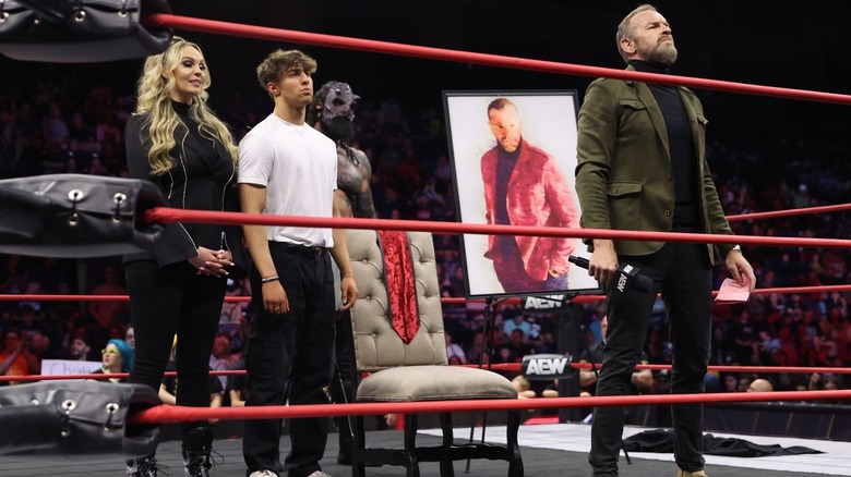 The Patriarchy in the ring with a painting of Christian Cage