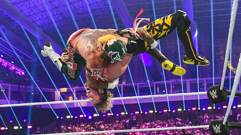 Logan Paul and Rey Mysterio flip through the air