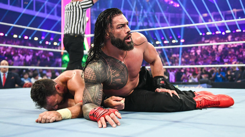 Roman Reigns trying to pin LA Knight