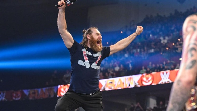 Sami Zayn stands in the turnbuckle, posing for the crowd before he address Dominik Mysterio on an episode of "WWE Raw."