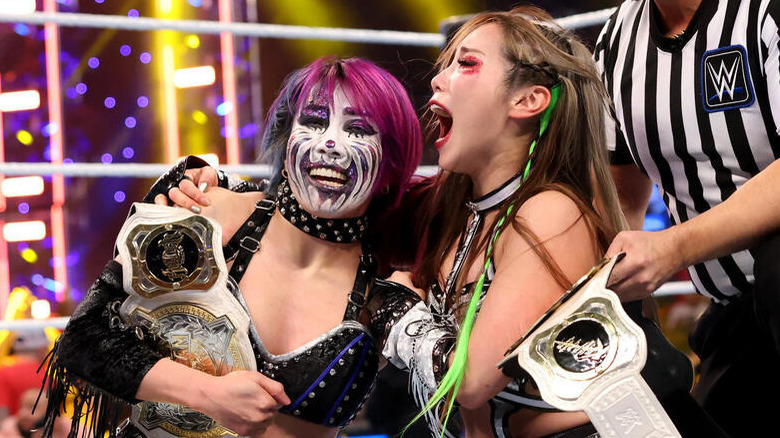 Kabuki Warriors in the ring with the Women's Tag Team titles