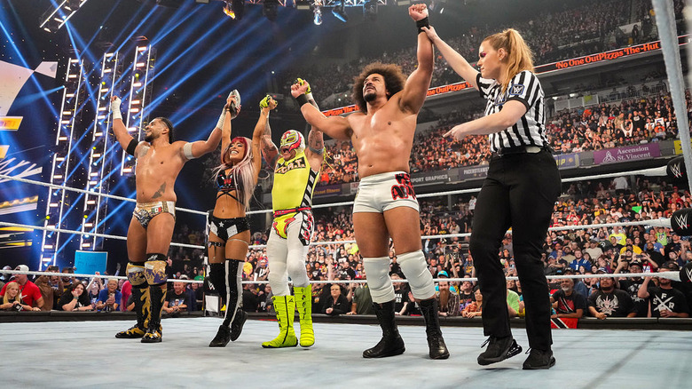 Carlito and the LWO raise their arms