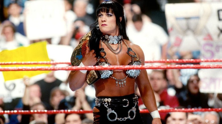 Chyna stands with the WWF Intercontinental Championship in the middle of the ring.