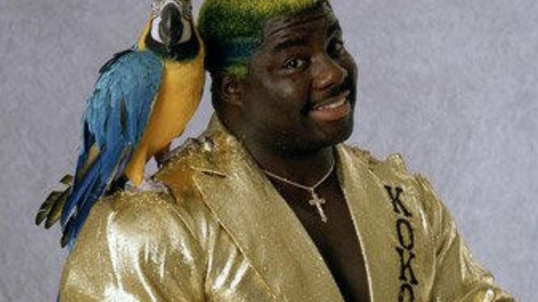 Koko B. Ware poses alongside his parrot in a backstage photoshoot for WWF.