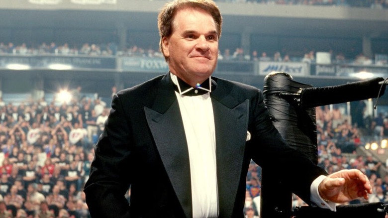 Pete Rose enters the ring in a tuxedo during a WWF event.