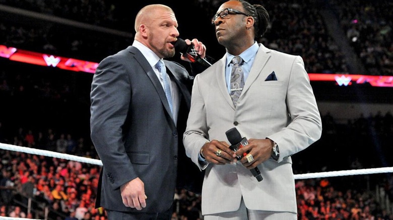 Paul "Triple H" Levesque addresses then-"WWE Raw" commentator Booker T in the middle of the ring during a segment on the show.