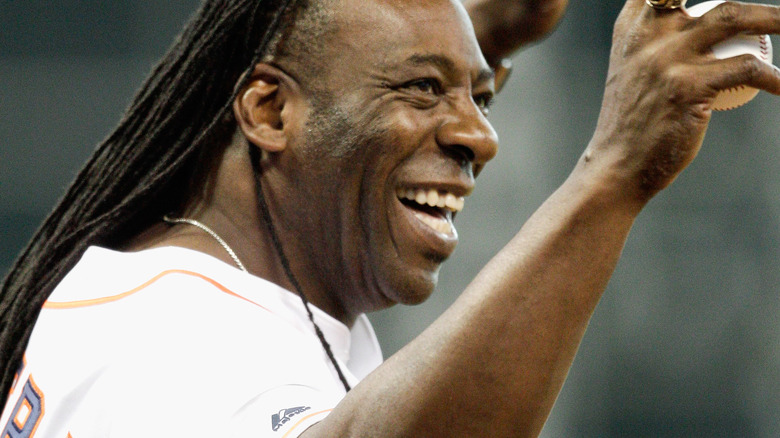 Booker T smiling and holding a baseball