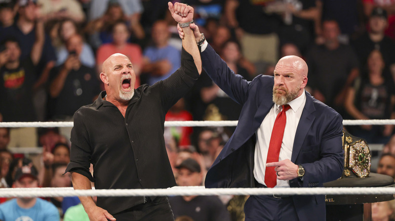 Bill Goldberg celebrates alongside Triple H