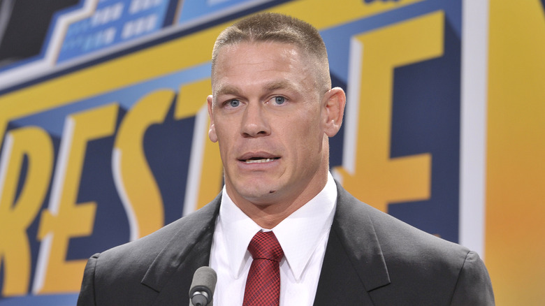 John Cena speaking in front of WrestleMania banner