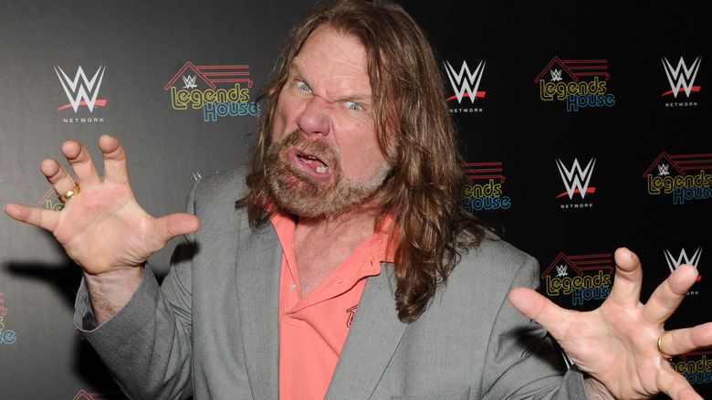 Jim Duggan making a face and claw hands