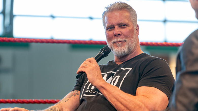 Kevin Nash with a microphone at a convention