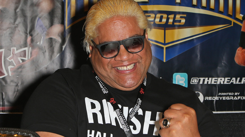 Rikishi wearing sunglasses and smiling