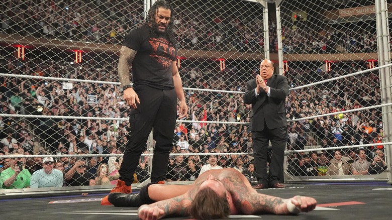 Roman Reigns standing over CM Punk after attacking him with Paul Heyman in the back. "Monday Night RAW," March 10th, 2025