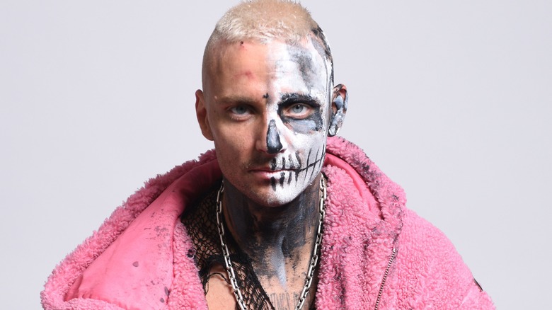 Darby Allin wearing a pink fur coat