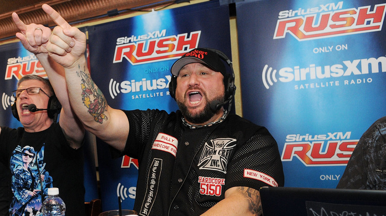 Bully Ray wearing a headset and pointing next to Dave LaGreca