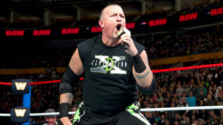 Road Dogg barks into a microphone, and is dressed head-to-toe in Degeneration X gear.