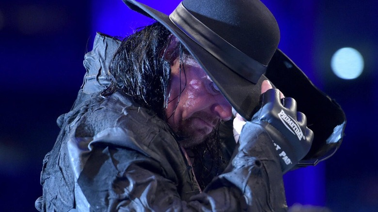 The Undertaker taking off his hat