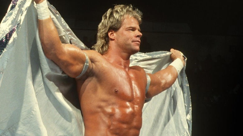 Lex Luger holds up his cape