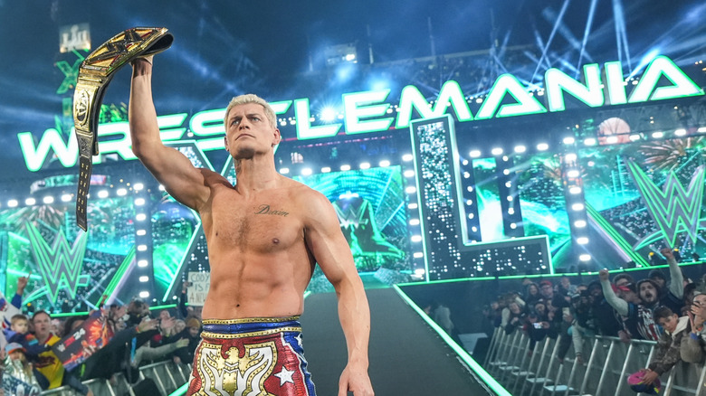 Cody Rhodes holds his newly won Undisputed WWE Championship at WrestleMania 40 last year