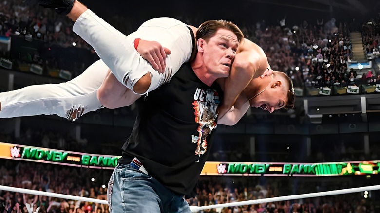 John Cena with Grayson Waller on his shoulders