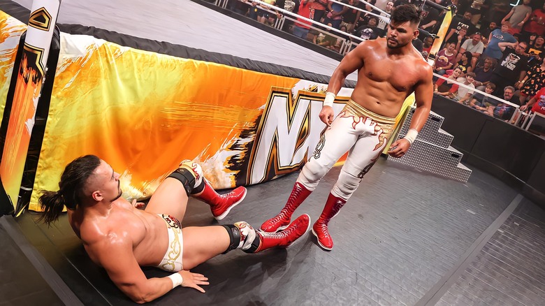 Humberto Carrillo standing over Angel Garza