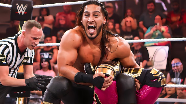 Mustafa Ali applying a submission hold