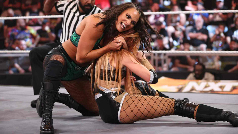 Kiana James with headlock on Becky Lynch