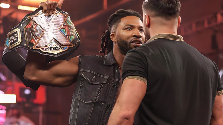 Trick Williams shows NXT title to Ethan Page