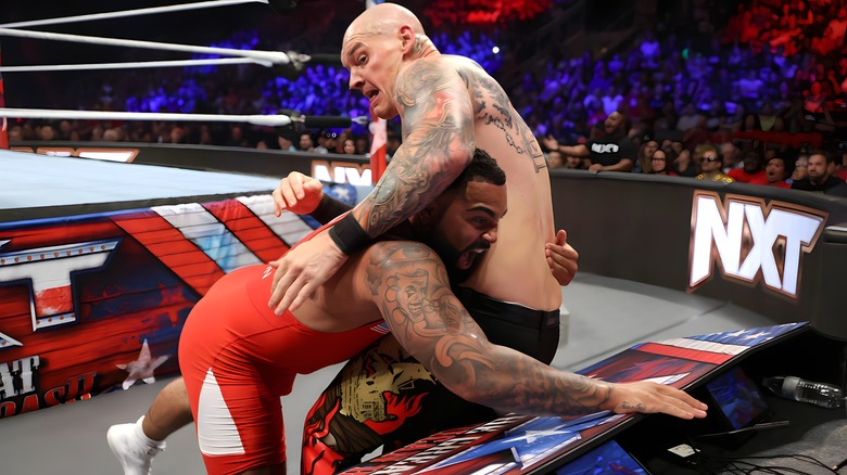 Gable Steveson drives Baron Corbin into a table