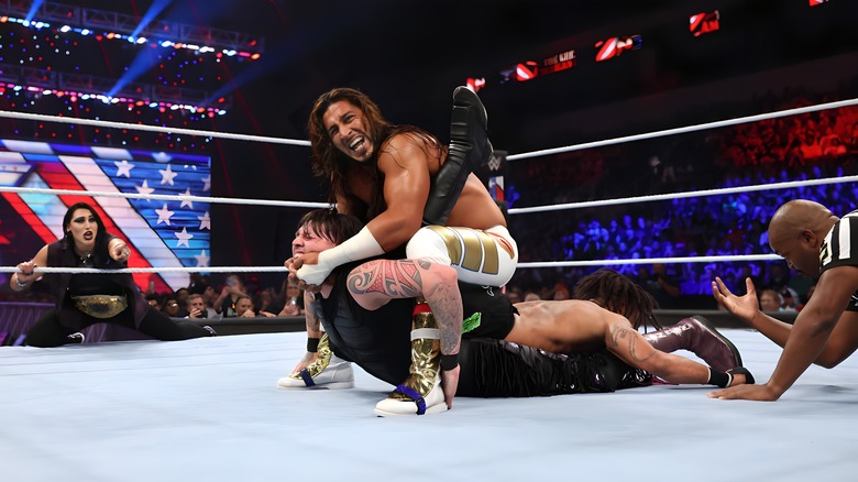 Mustafa Ali with a submission hold on both his opponents