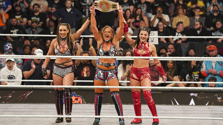 Fallon Henley celebrates her women's North American title win alongside Fatal Influence at "WWE NXT" Halloween Havoc.