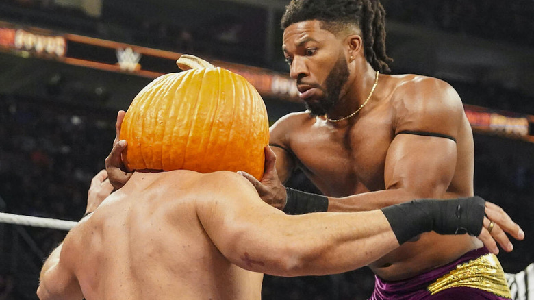 Trick Williams puts a pumpkin on Ethan Page's head at "WWE NXT" Halloween Havoc.