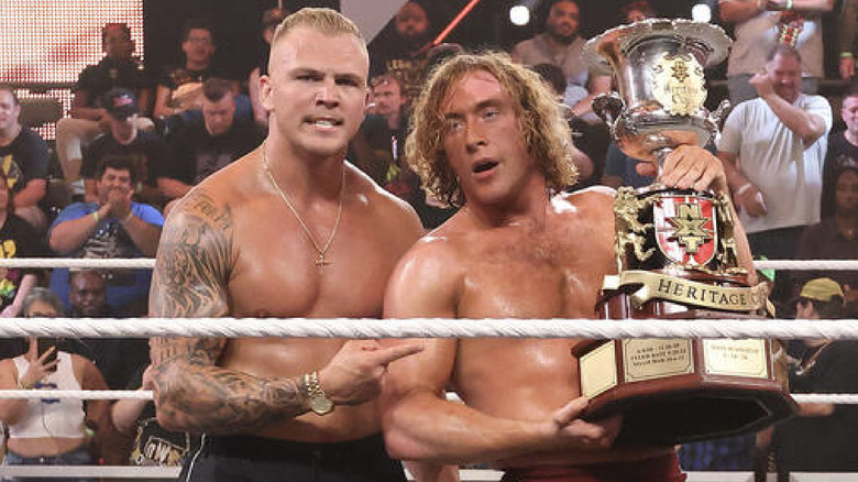 Dempsey holding up the Heritage Cup as Myles Borne stands next to him