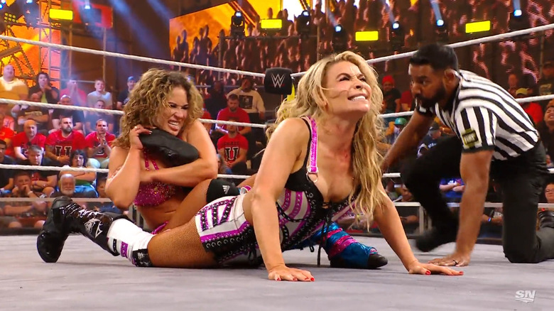 Vice landing a kick on Natalya's head