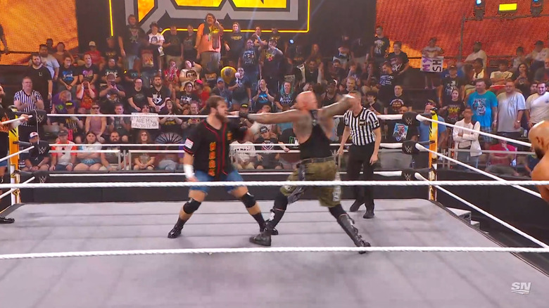 Walker and Gallows brawling in the ring